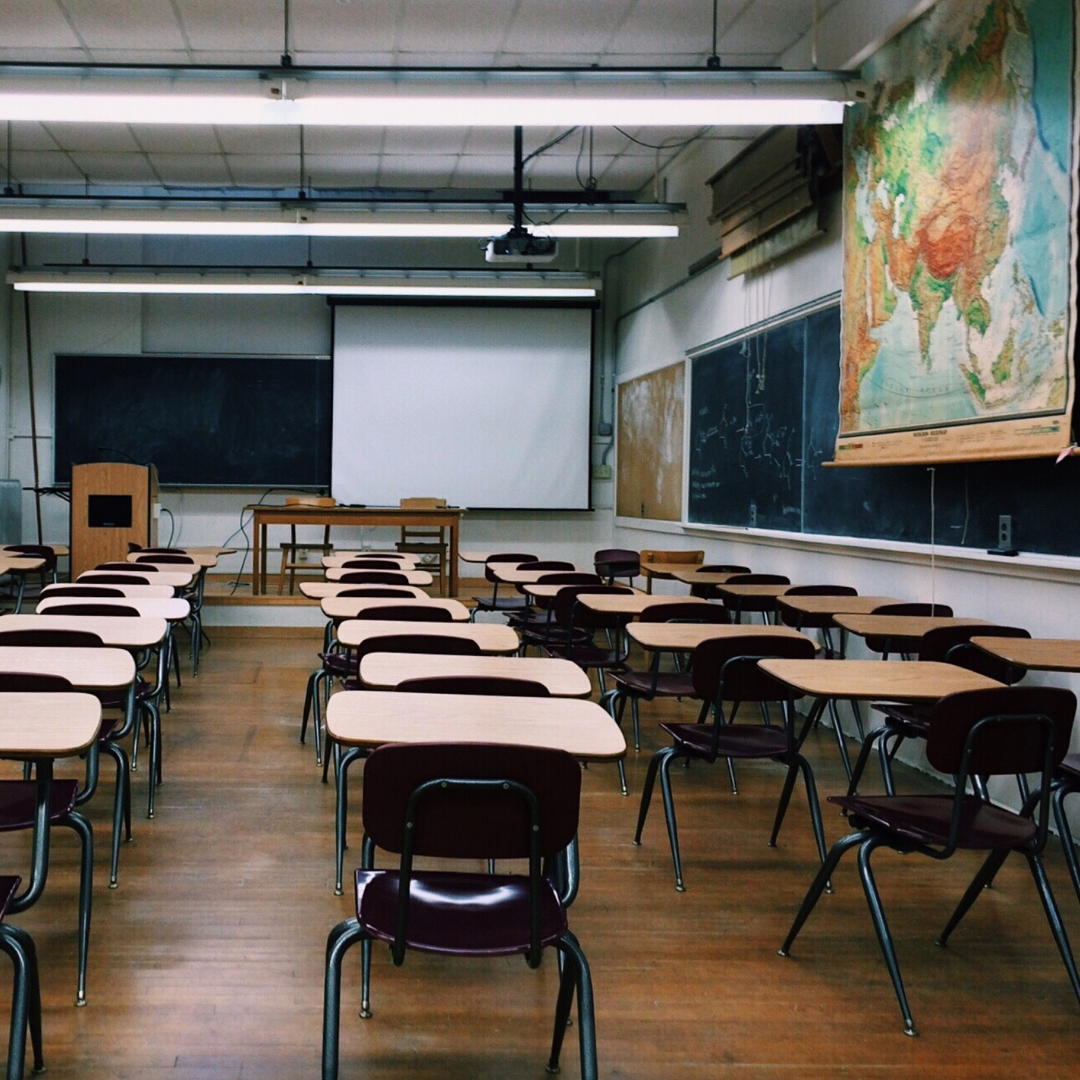 school classroom filled with chairs and blackboards